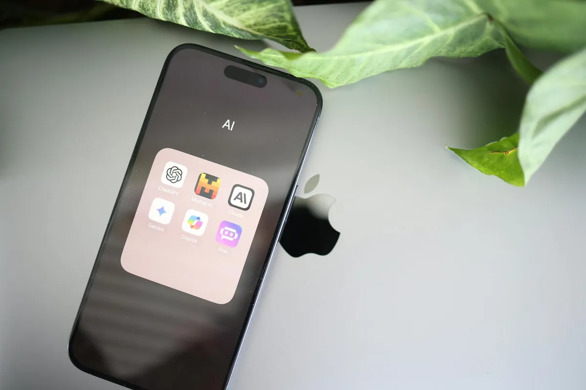A modern workspace with multiple devices showing AI chatbot interfaces